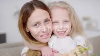 Happy Little Girl with Flowers Hugging Mother | Stock Footage - Envato elements