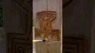 Oiling up Thor's Hammer Carved into a fence post.