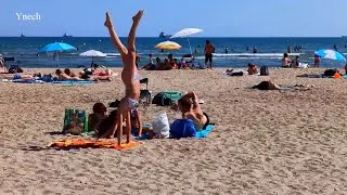 Fos-sur-Mer beach, France today. Girls doing a handstand on the beach.