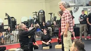 Richard Norton guides the TKC students on their first time breaking boards