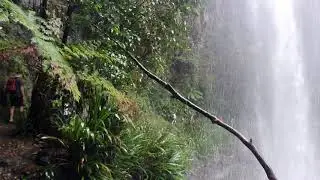 Passing behind the main falls