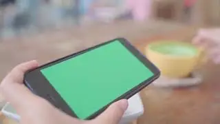 Young asian woman using black mobile phone device with green screen    Free HD Video Clips