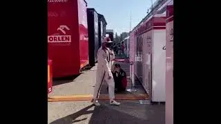 Kimi Raikkonen walks to his garage...