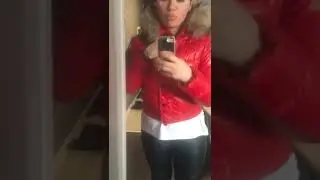 A girl in red glossy Moncler Alpin puffy down jacket with hood and fur; and black leather leggings.