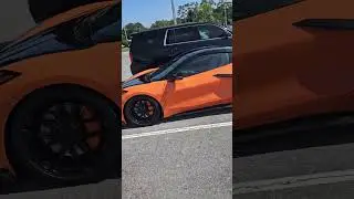 Corvette 2023 Orange and black in the parking lot