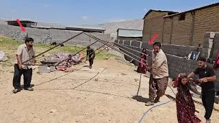 Amir and Fatima from the Kohrig family help Ayas and his father build a shelter for the sheep
