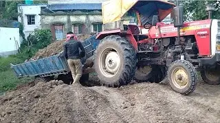 mahindratractor, johndeartractor unloading mud....