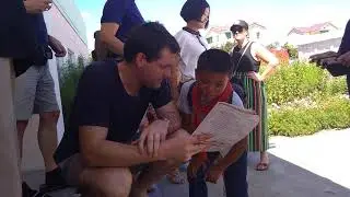 Troy from Young Pioneer Tours helping North Korean kid with English homework