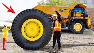 Senya is repairing a fallen wheel on a huge tractor