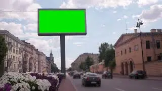 A billboard with a green screen on a busy street Chroma key