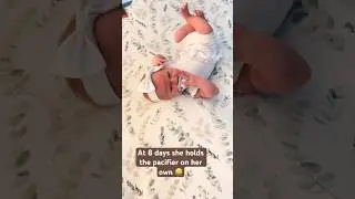 Independent child 😀 at 8 days holds her pacifier by herself