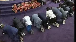 Bishop GE Patterson leads a prayer meeting.