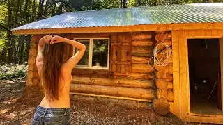 A cozy night with his wife in a wooden hut. Autonomous house in the wild forest