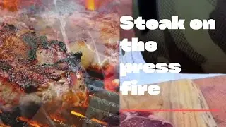 Steak on the press fire