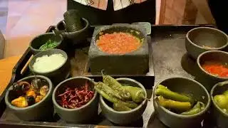 chef shows how to make a delicious salsa using a fork & spoon & mortar & pestle