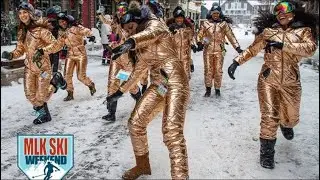 Girls in shiny winter ski suits and shining Sergio Parrero overalls have fun in snow at ski resort.