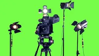 professional studio spotlights and a professional video camera green screen background