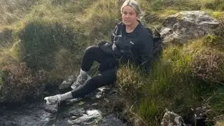 Girl falls after attempting to slide down wet rock on hike || WooGlobe