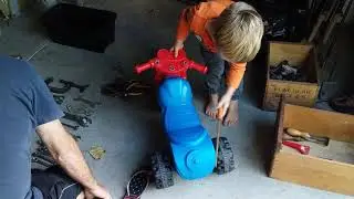Oscar fixing his motorbike