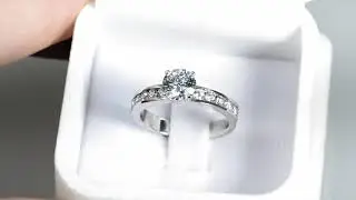 Round Cut Engagement Ring With a Wide Band and Accent Stones