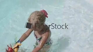 Playful little girl with mom in outside pool