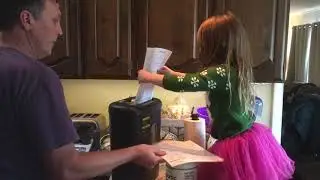 Little girl likes to shred paper.