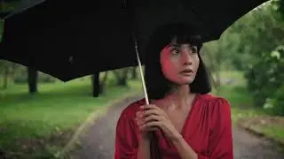 free stock footages | girl with an umbrella walking through a park