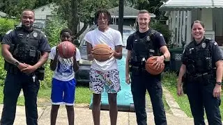 Police officers join neighborhood pick-up game