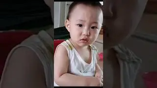 Baby Minguk sits and eats sausage... delicious and delicious!