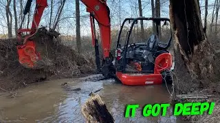 Mini excavator working flood waters
