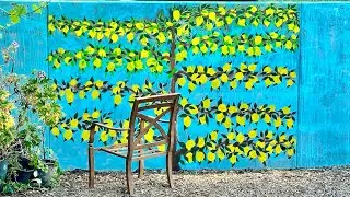 Muraling espalier fruit trees on a concrete wall. Painting on concrete.