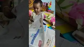 Tiny Newsreader: Dhanvika's First Peek at the Newspaper!
