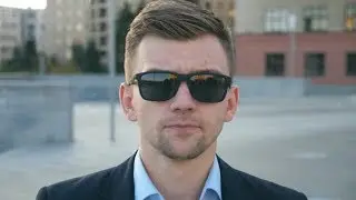 Portrait of Young Businessman in Sunglasses Walking in City Street. Handsome Business Man Stepping