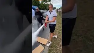 Eco protesters blasted with fire extinguisher as they sit in the road