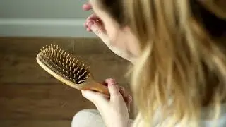 drop down hair in female hands with comb 2022 08 04 12 02 38 utc