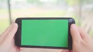 Green Screen Effects || Young Asian Woman Using Black Mobile Phone Device With Green Screen.