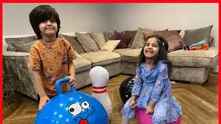 Aana and Aadam play with inflatable bowling ball set and space hoppers