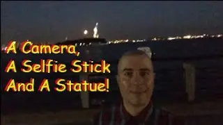 A Camera, A Selfie Stick And A Statue