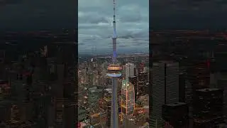 As night falls, the CN Tower illuminates Toronto's evening skyline.