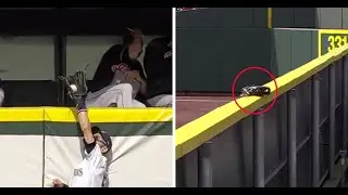 Ichiro Suzuki reaches over the fence to rob a home run