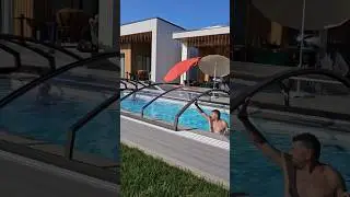 An outdoor swimming pool with a retractable roof on a country property