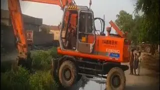Excavator Crossing canal With Arm