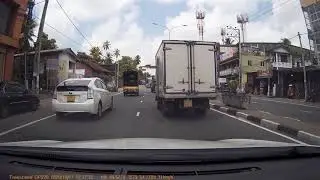 Near Miss - Lady on a scooter almost collides with a car