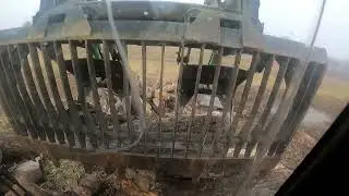 Lazy afternoon stacking firewood logs with a grapple bucket
