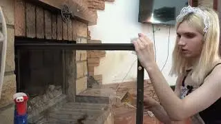 Hell_Kitty cleans glass on fireplace
