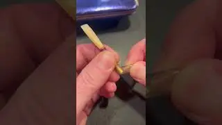 Putting a piece of aquarium tubing on an English horn reed.