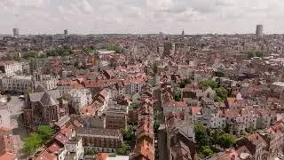 Panning over Brussels reveals a charming cityscape with traditional architecture and red tiled roofs