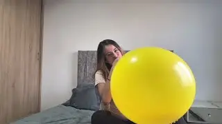 Inflating a giant yellow balloon until bursts
