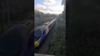 An Avanti West Coast pride liveried class 390 passes Abington 