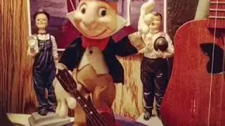 JIMINY CRICKET JUGGLES A UKULELE